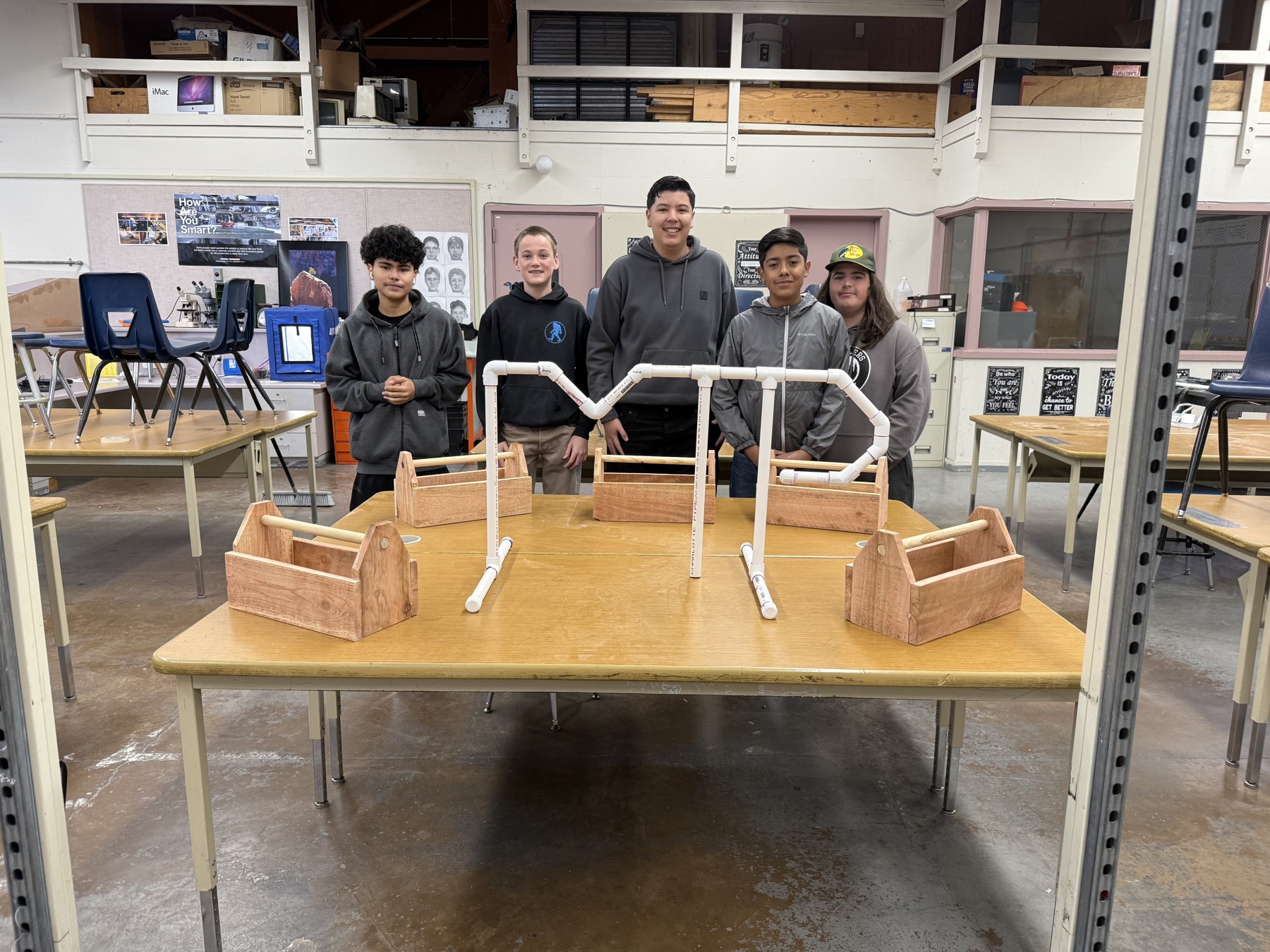 A group standing behind a model construction project