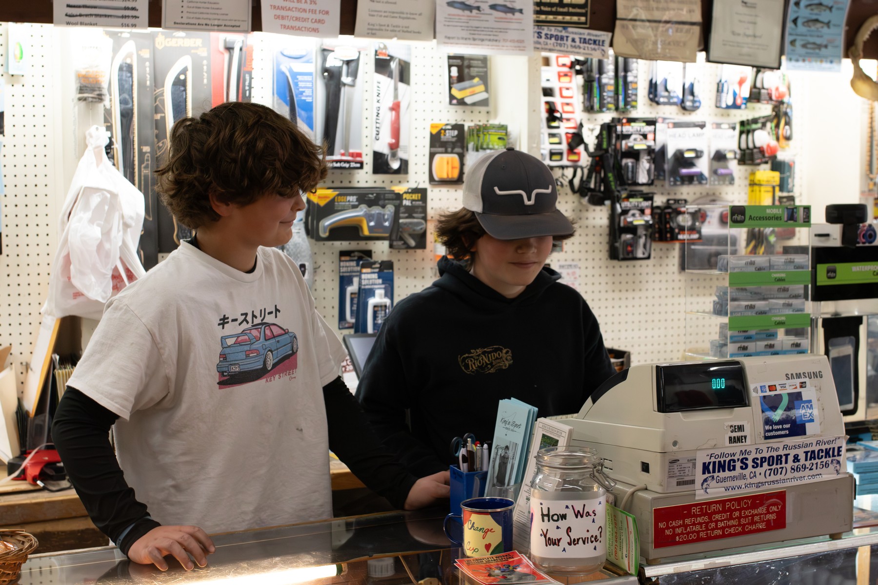 Two students learning at a sporting goods counter