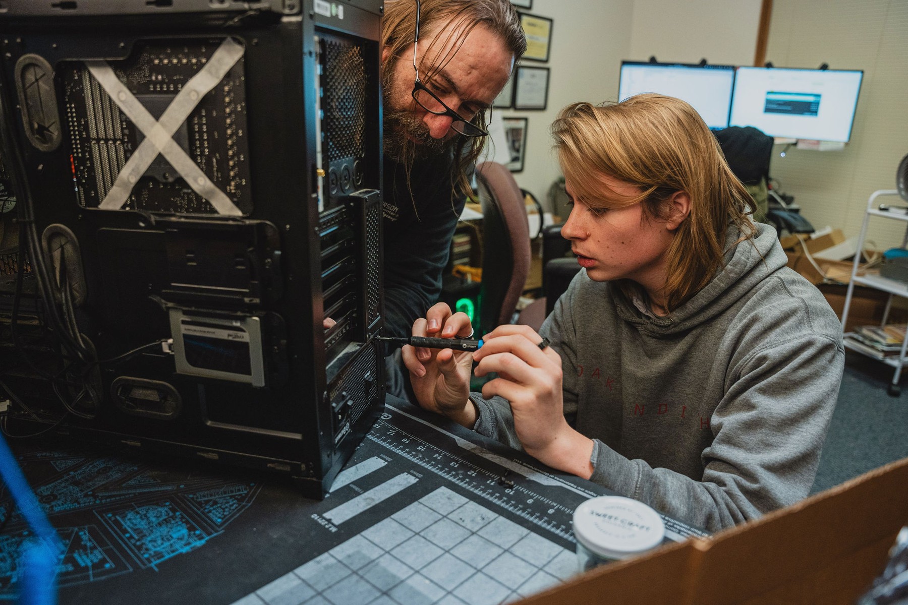 A student and mentor examining computer components