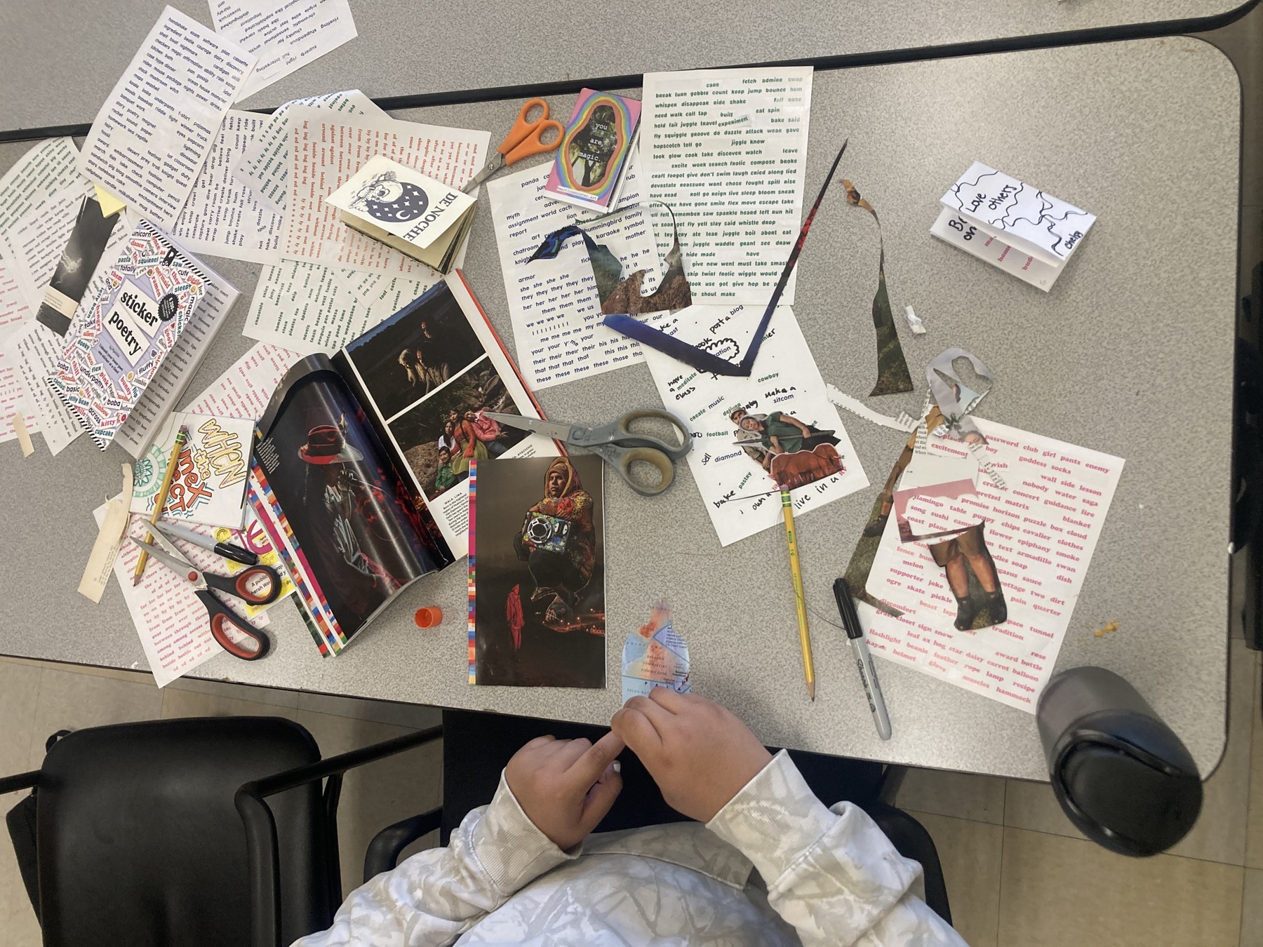 A student planning a creative project with paper and drawings