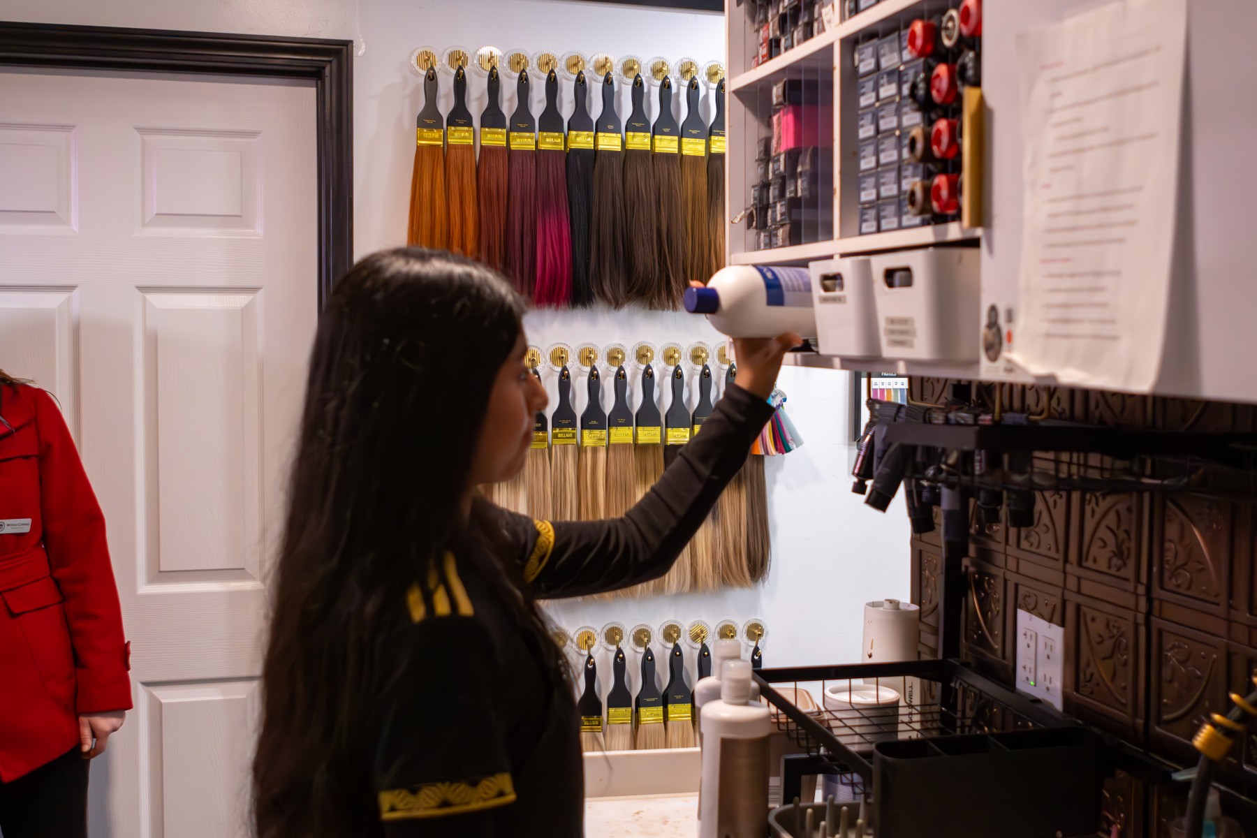 A student selecting products in a hair salon