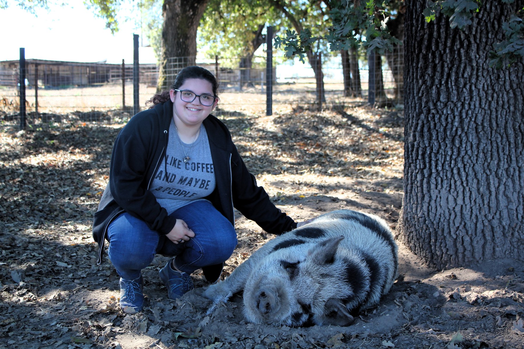 A participant spending time with a goat outdoors
